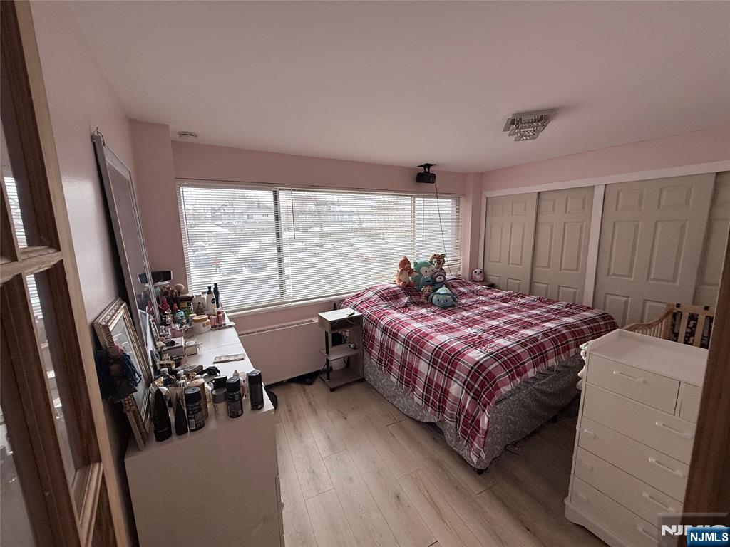 265 Main Street, Unit 113 Ridgefield Park, NJ 07660 - Photo 13 of 13 a bedroom with a bed and a large window