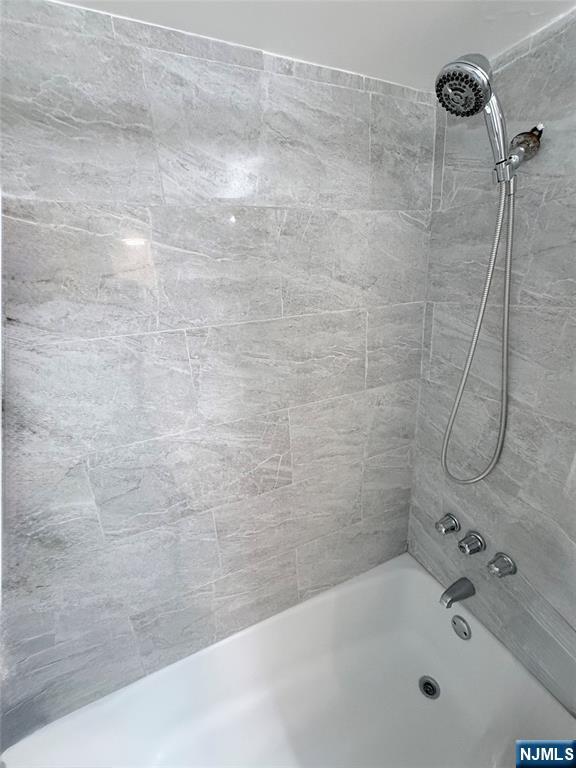 265 Main Street, Unit 113 Ridgefield Park, NJ 07660 - Photo 5 of 13 a bathroom with a bathtub