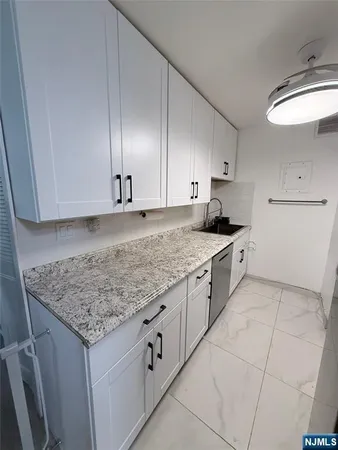 a kitchen with granite countertop cabinets and sink