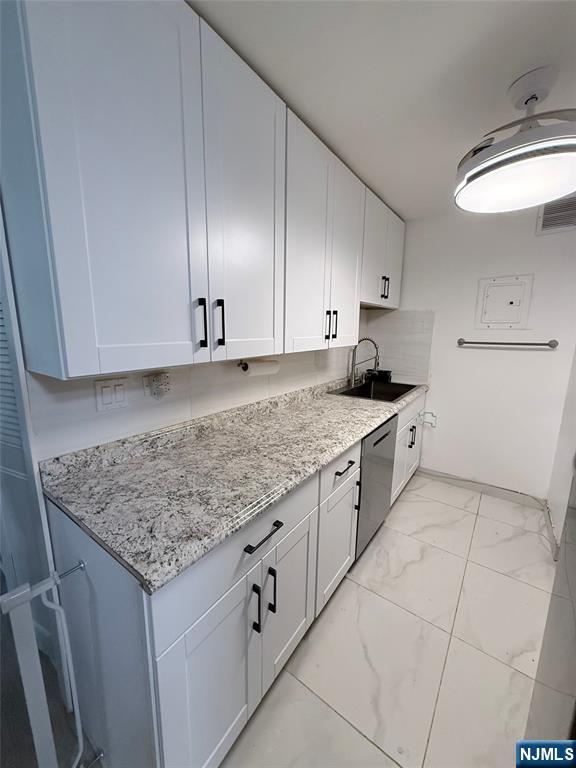 265 Main Street, Unit 113 Ridgefield Park, NJ 07660 - Photo 6 of 13 a kitchen with granite countertop cabinets and sink