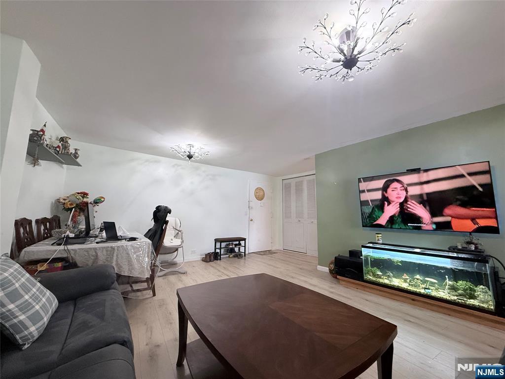 265 Main Street, Unit 113 Ridgefield Park, NJ 07660 - Photo 10 of 13 a living room with furniture and a flat screen tv