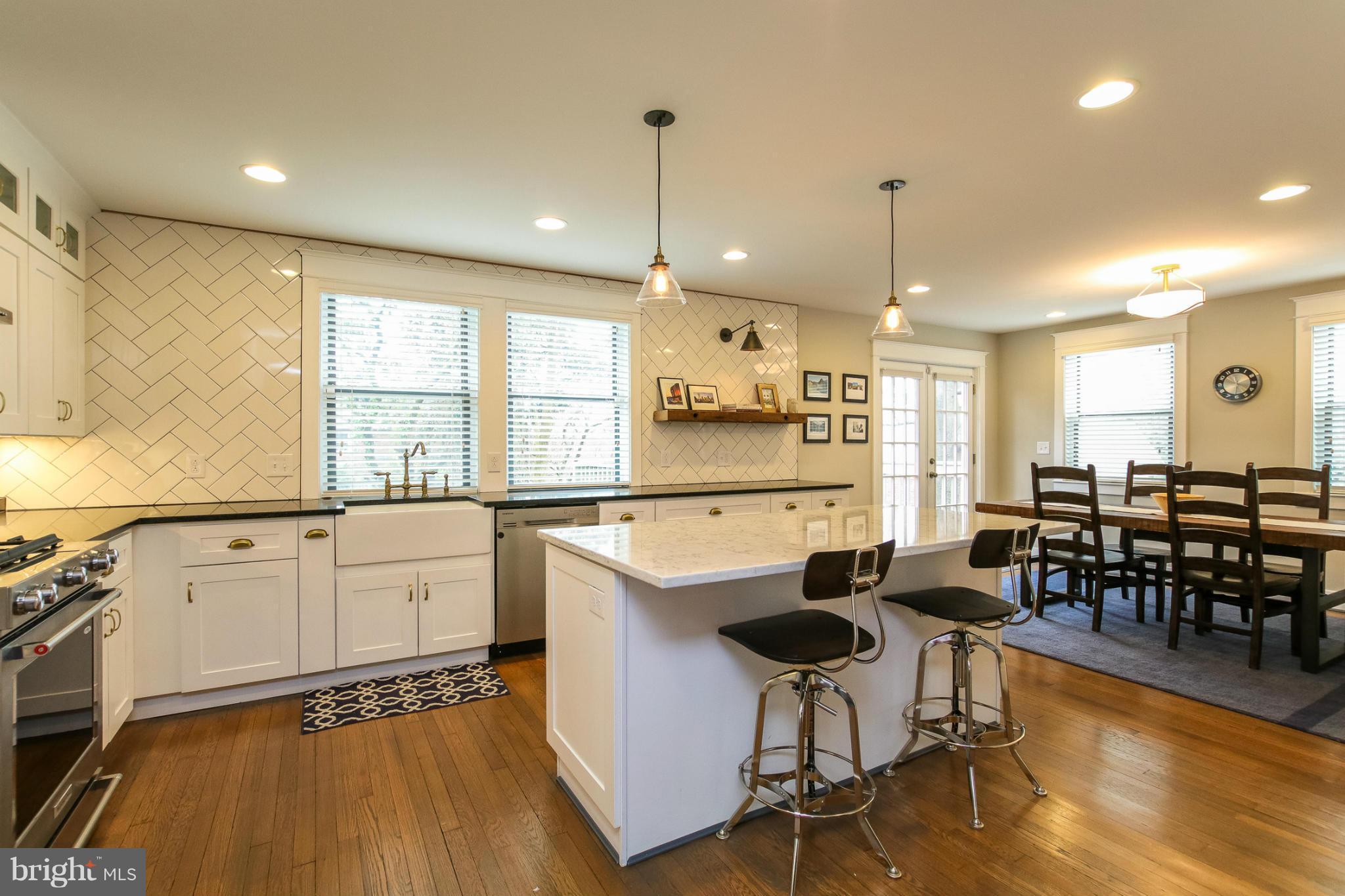 829 Kingston Road Baltimore, MD 21212 - Photo 11 of 30 a large kitchen with lots of counter space and a dining table