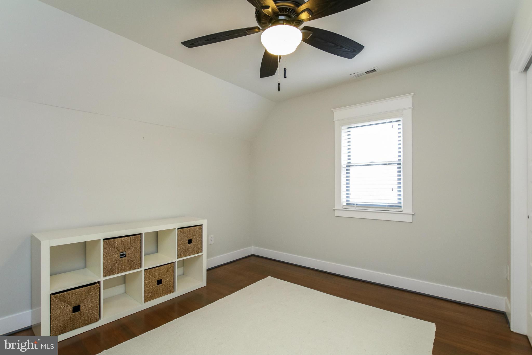 829 Kingston Road Baltimore, MD 21212 - Photo 17 of 30 a view of an empty room with a window and wooden floor