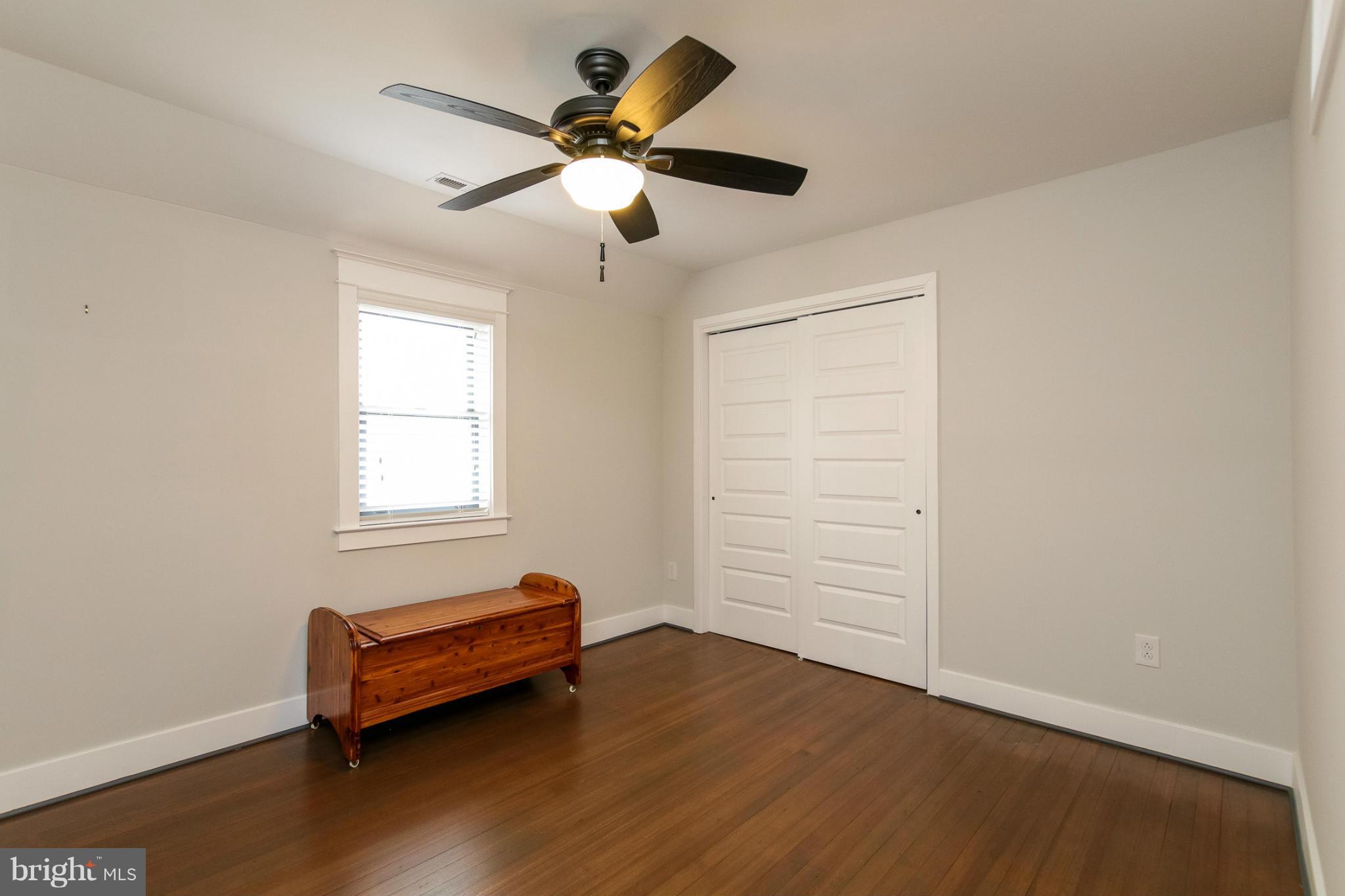 829 Kingston Road Baltimore, MD 21212 - Photo 18 of 30 an empty room with wooden floor and windows