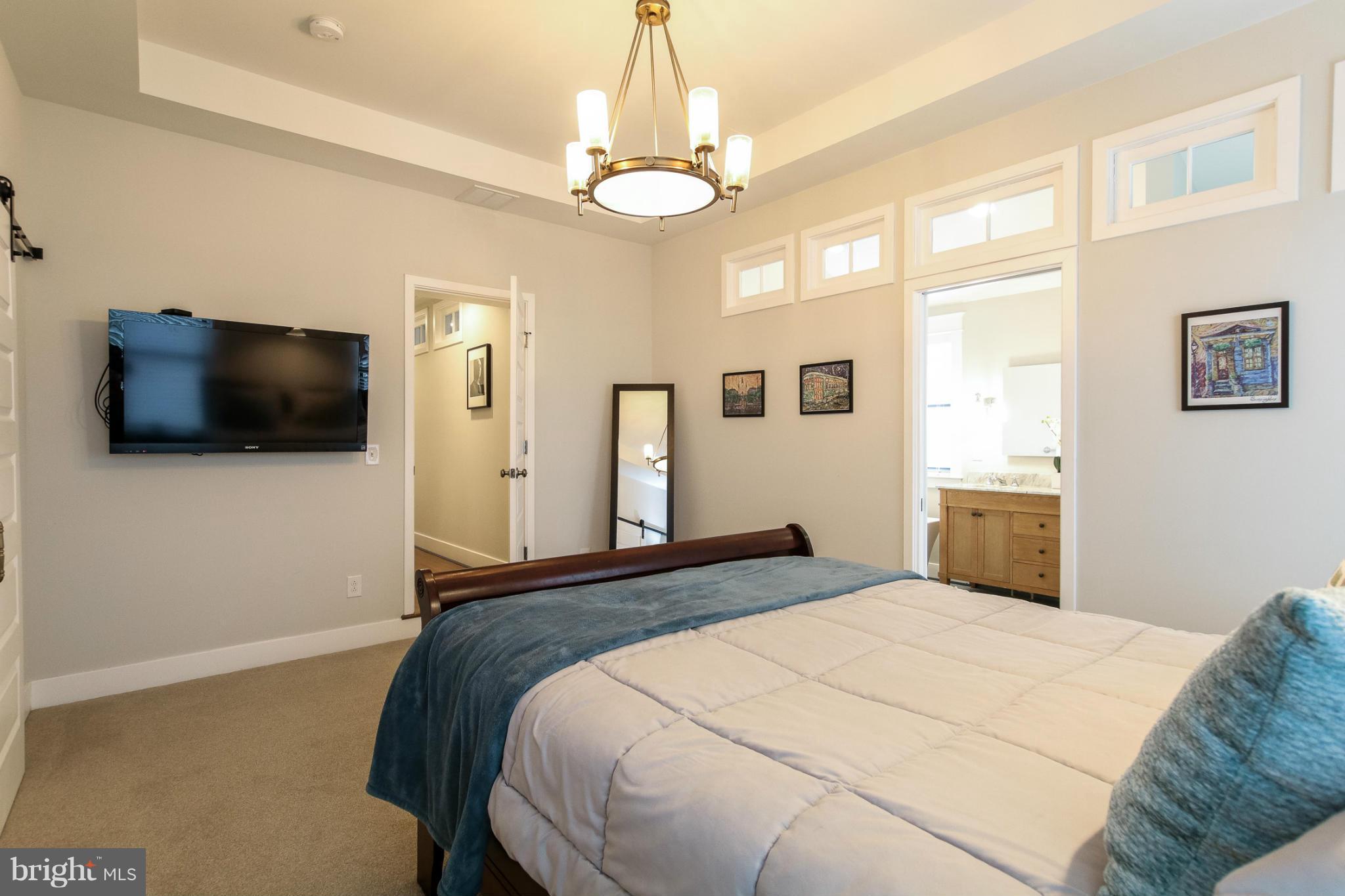 829 Kingston Road Baltimore, MD 21212 - Photo 22 of 30 a bedroom with a bed and a flat screen tv