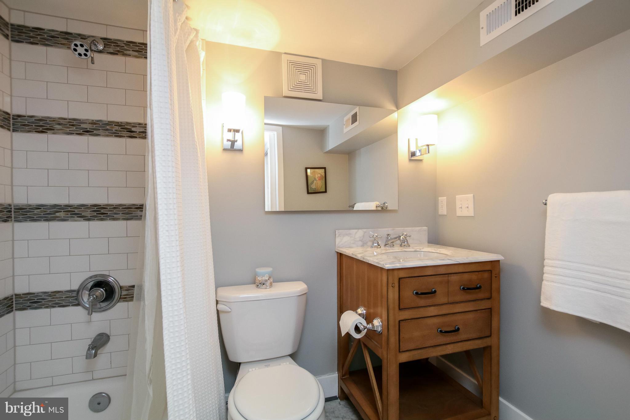 829 Kingston Road Baltimore, MD 21212 - Photo 28 of 30 a bathroom with a toilet a sink and shower