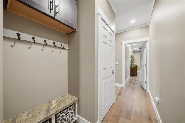 a view of a hallway with wooden floor