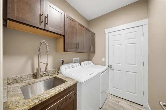 a kitchen with a sink cabinets and utility
