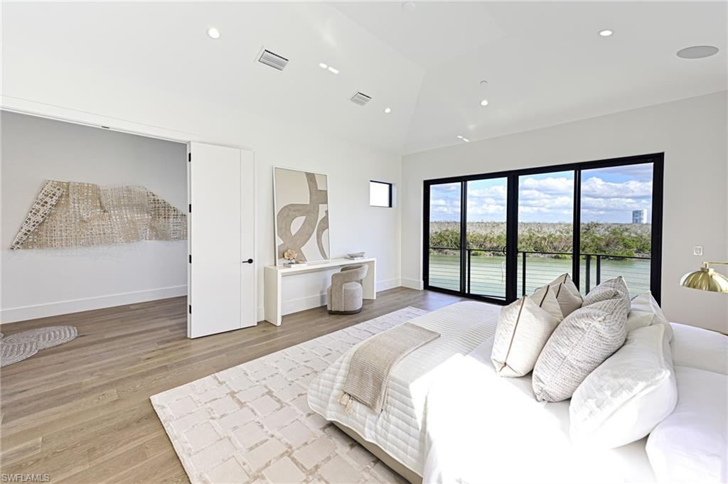 26415 Bay Road Bonita Springs, FL 34134 - Photo 23 of 42 a spacious bedroom with a large bed and a large window