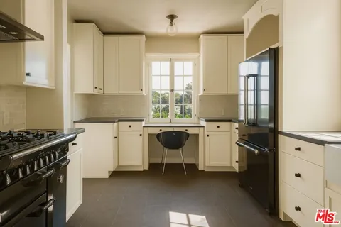 a kitchen with a sink and wooden cabinets