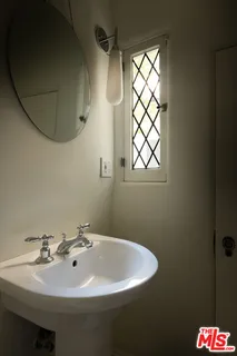 a spacious bedroom with a bed and large windows