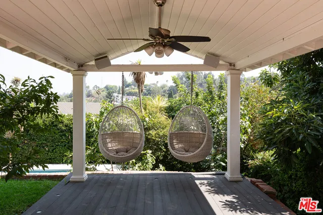 a view of a backyard with table and chairs