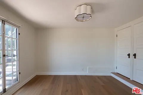 a view of a room with wooden floor
