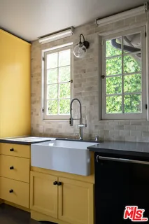 a view of a room with wooden floor and windows