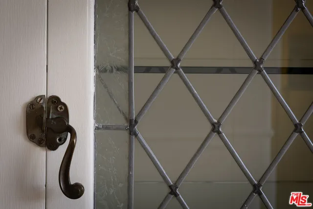 a kitchen with a stove a sink and white cabinets