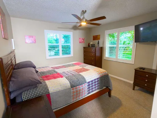 a bedroom with a bed and a dresser in it