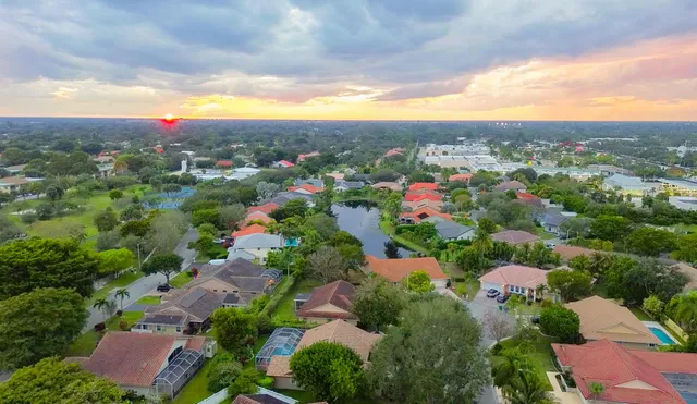 a front view of a house with a yard and a garage