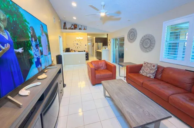 a bathroom with a granite countertop sink a large mirror and a window
