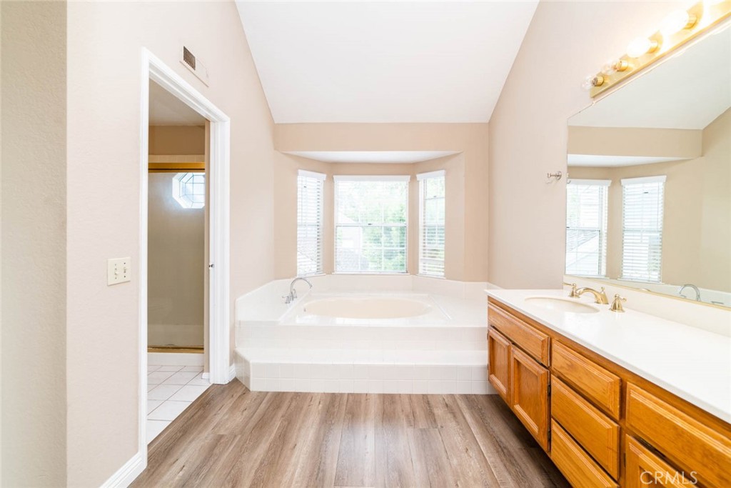 25 Parkman Road East Laguna Niguel, CA 92677 - Photo 23 of 36 a spacious bathroom with a bathtub sink and mirror