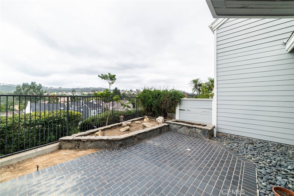 25 Parkman Road East Laguna Niguel, CA 92677 - Photo 28 of 36 a view of a lake with a bench and wooden floor