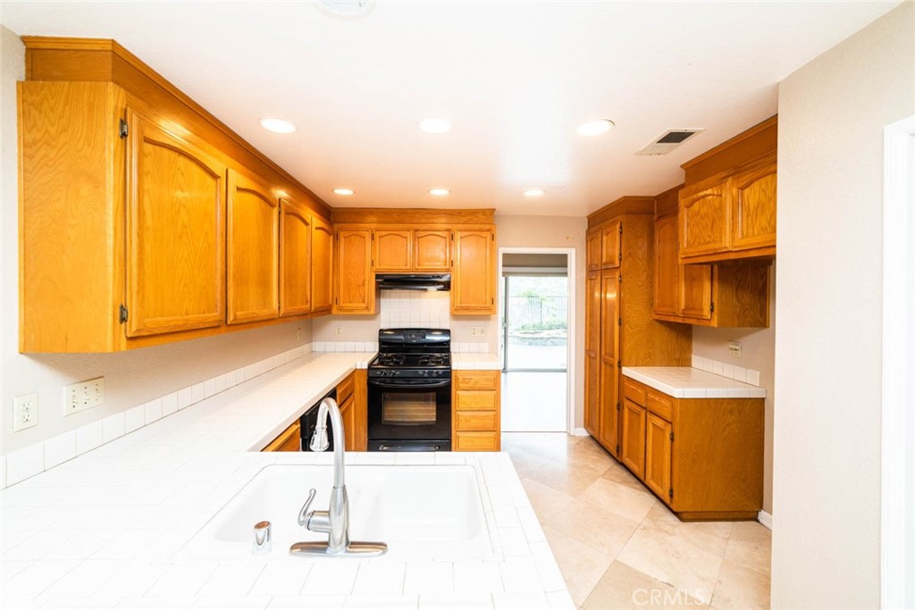 25 Parkman Road East Laguna Niguel, CA 92677 - Photo 5 of 36 a kitchen with stainless steel appliances kitchen island granite countertop a refrigerator and a stove top oven