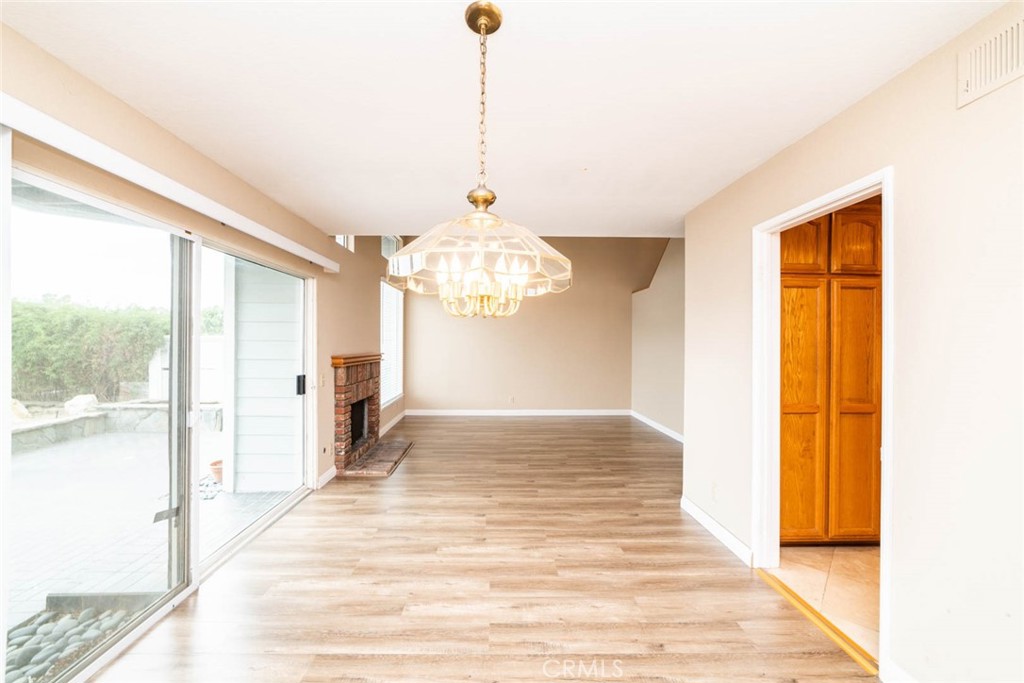 25 Parkman Road East Laguna Niguel, CA 92677 - Photo 6 of 36 a view of a hallway with wooden floor and a chandelier