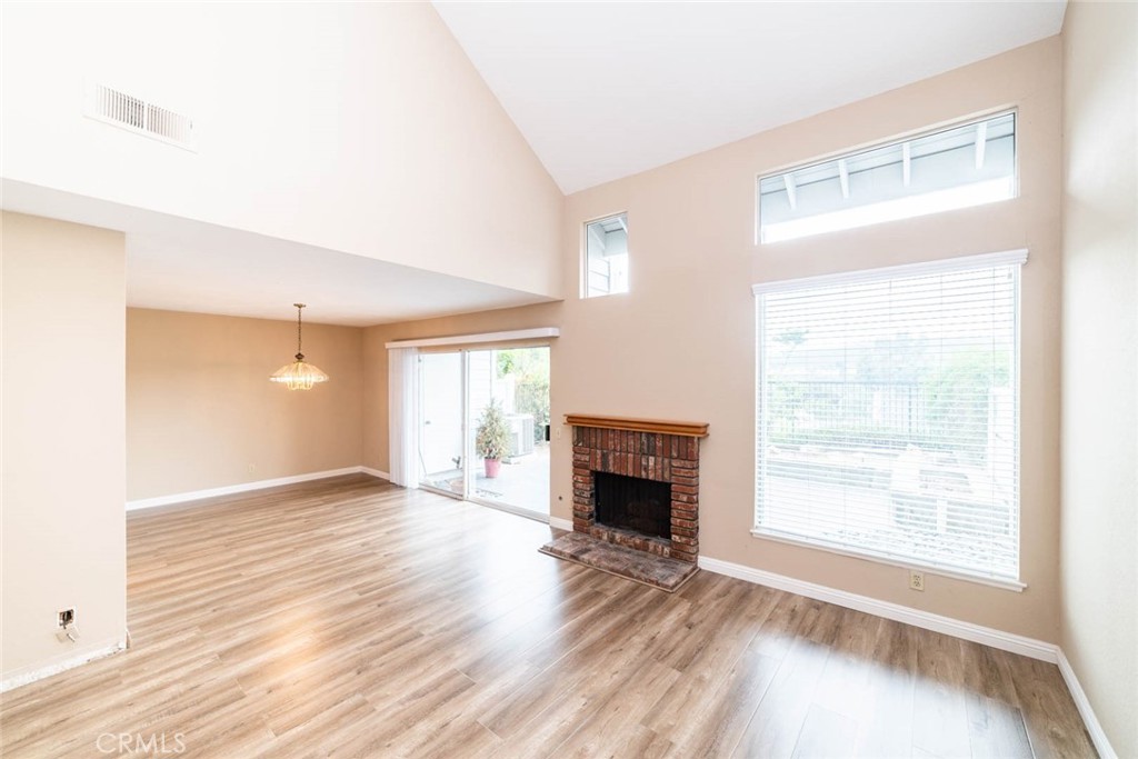 25 Parkman Road East Laguna Niguel, CA 92677 - Photo 8 of 36 a view of an empty room with wooden floor fireplace and a window