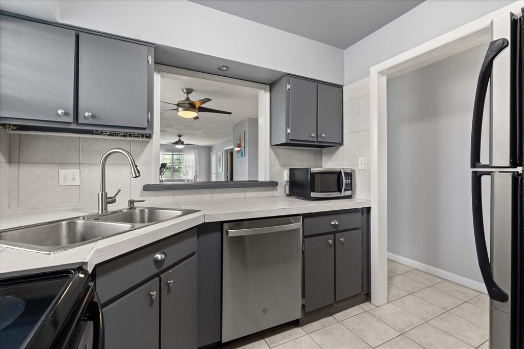 2500 Lee Road, Unit 208 Winter Park, FL 32789 - Photo 12 of 49 a kitchen with stainless steel appliances granite countertop a sink stove and refrigerator