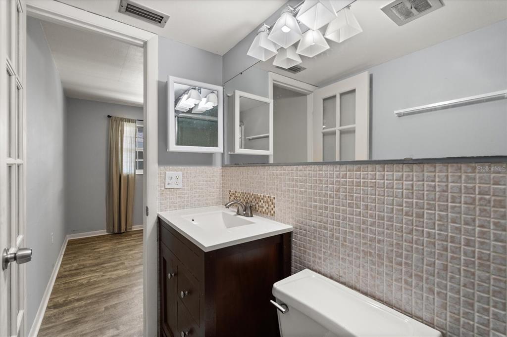 2500 Lee Road, Unit 208 Winter Park, FL 32789 - Photo 17 of 49 a bathroom with a sink a toilet and mirror