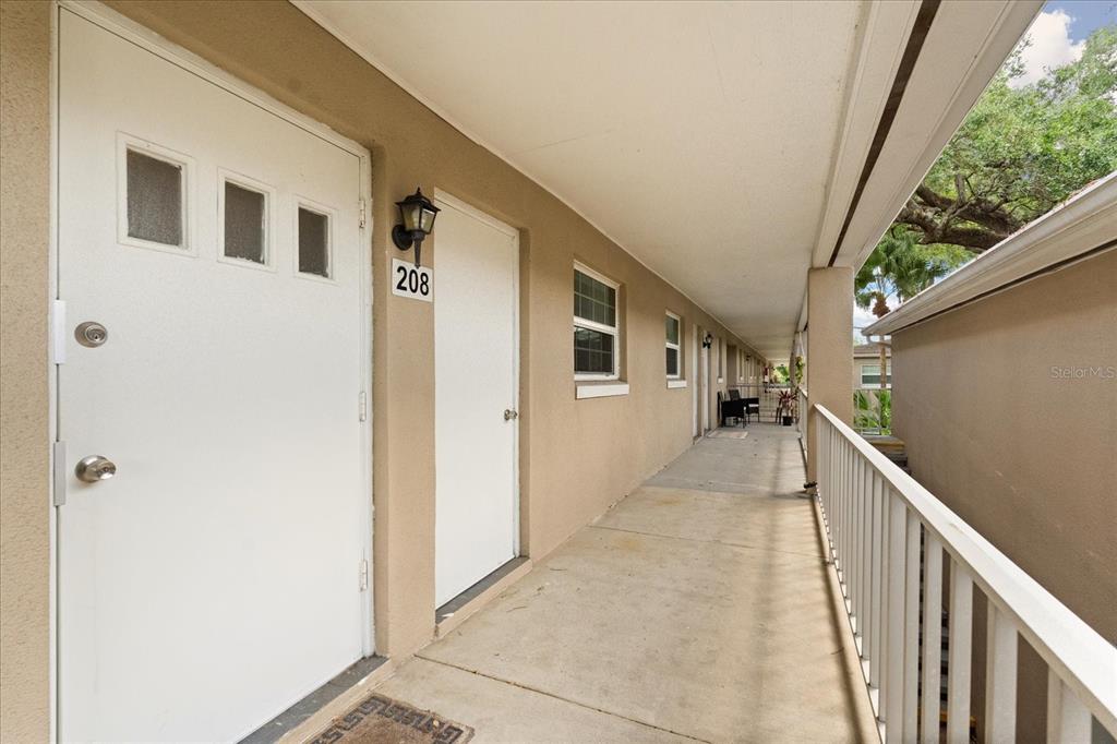 2500 Lee Road, Unit 208 Winter Park, FL 32789 - Photo 23 of 49 a view of a porch with wooden floor and stairs