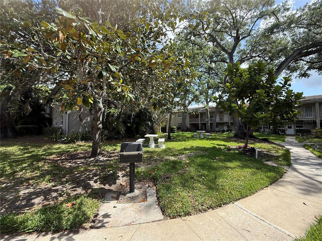 2500 Lee Road, Unit 208 Winter Park, FL 32789 - Photo 27 of 49 a view of a garden with a bench