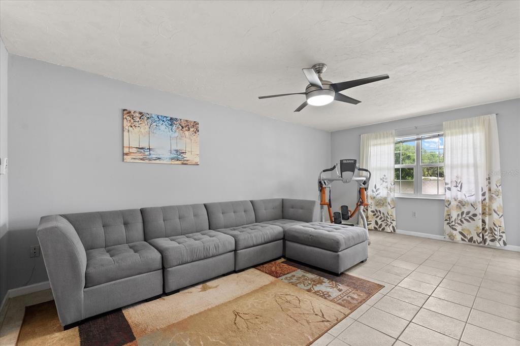 2500 Lee Road, Unit 208 Winter Park, FL 32789 - Photo 4 of 49 a living room with furniture and a large window