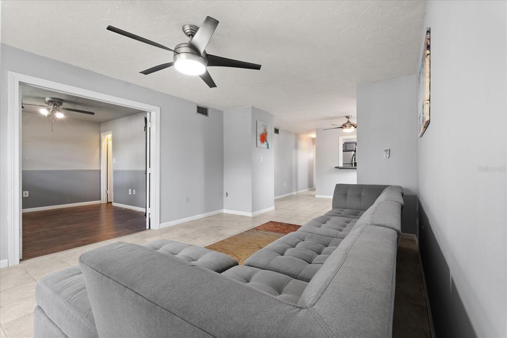 2500 Lee Road, Unit 208 Winter Park, FL 32789 - Photo 6 of 49 a spacious bedroom with a bed and a chandelier