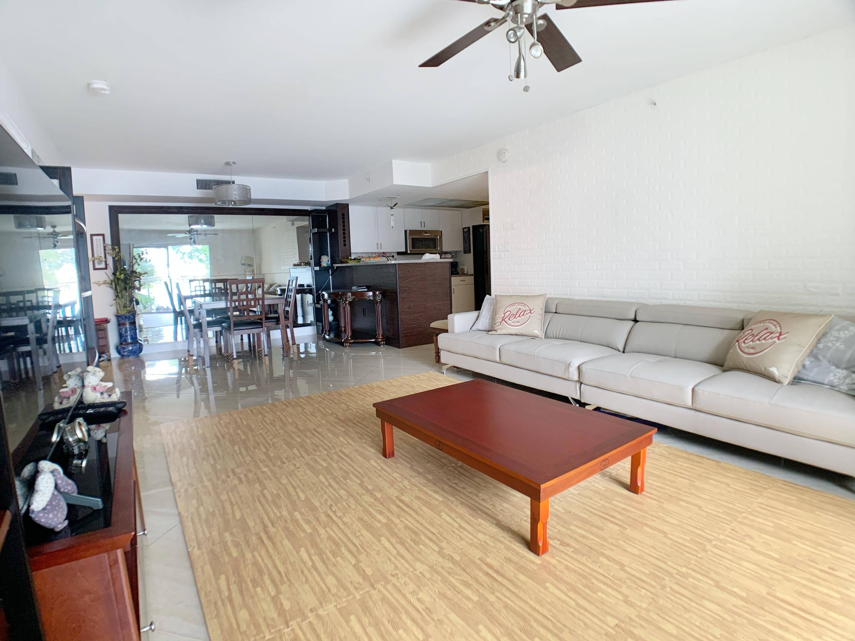 5015 Wiles Road, Unit 206 Coconut Creek, FL 33073 - Photo 13 of 32 a living room with furniture