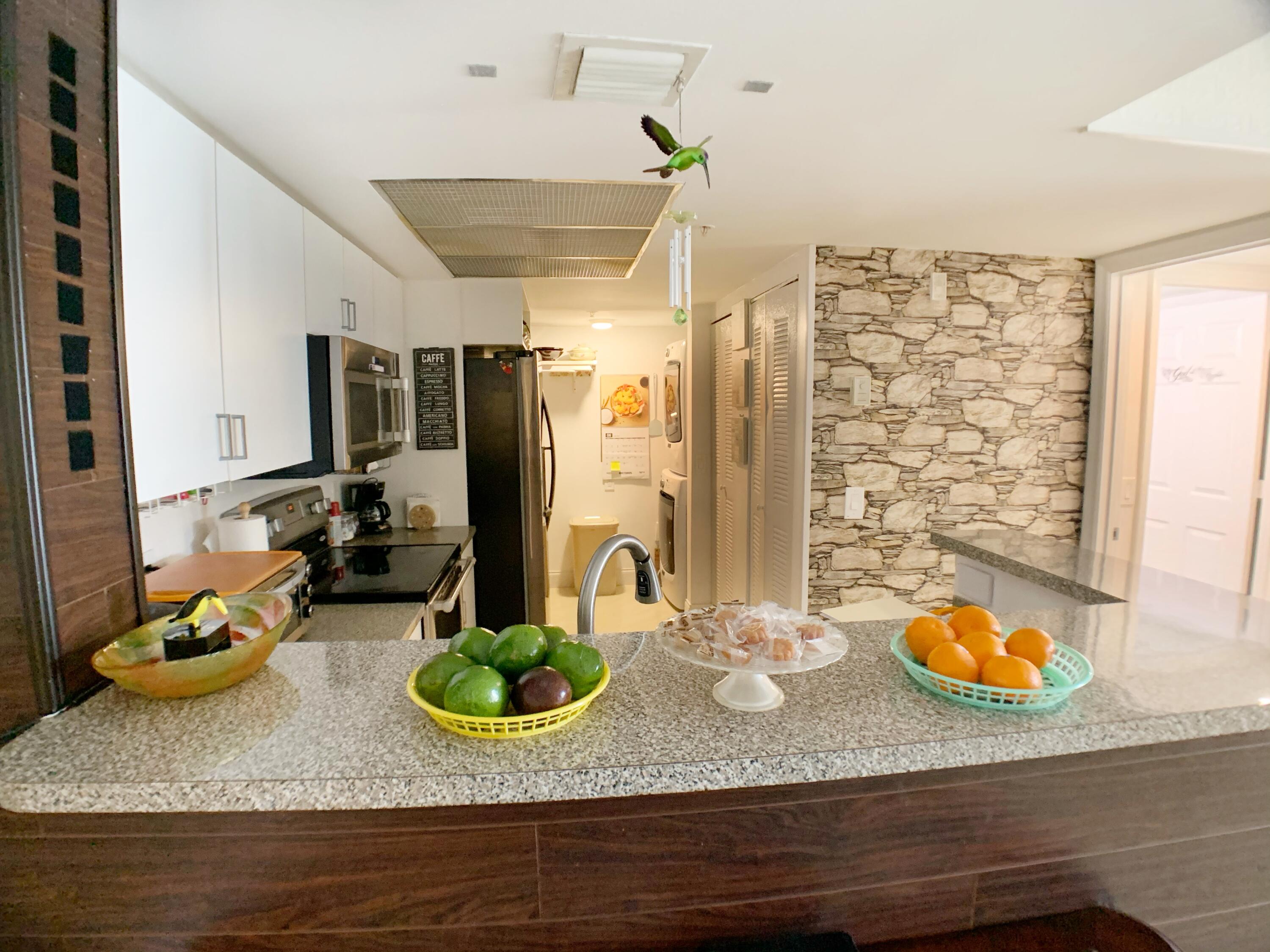 5015 Wiles Road, Unit 206 Coconut Creek, FL 33073 - Photo 15 of 32 a dining room with wooden floor