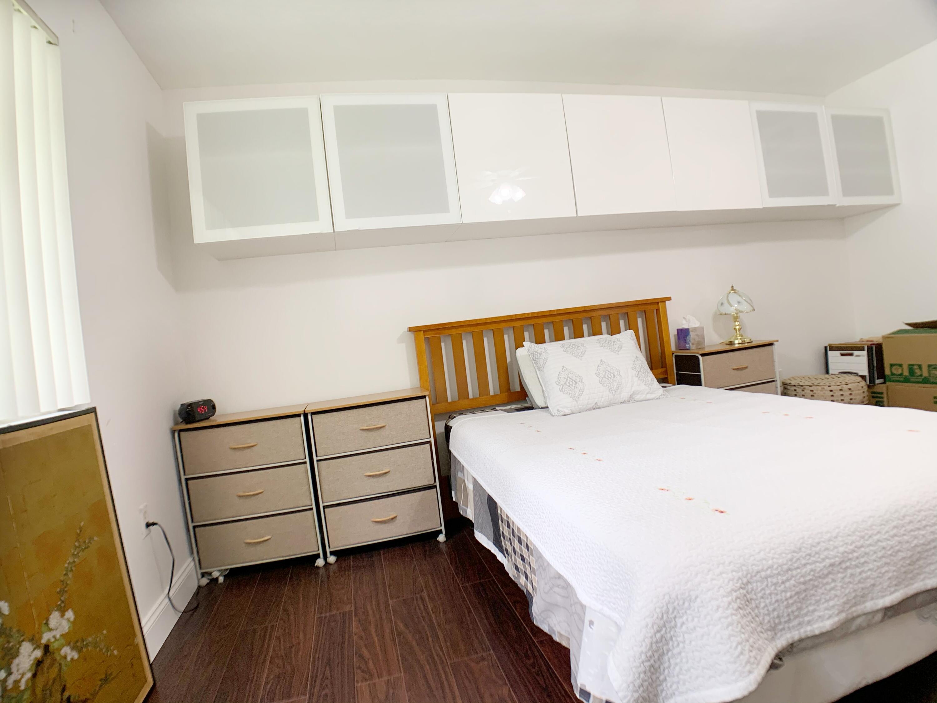 5015 Wiles Road, Unit 206 Coconut Creek, FL 33073 - Photo 21 of 32 a bedroom with a bed and a window