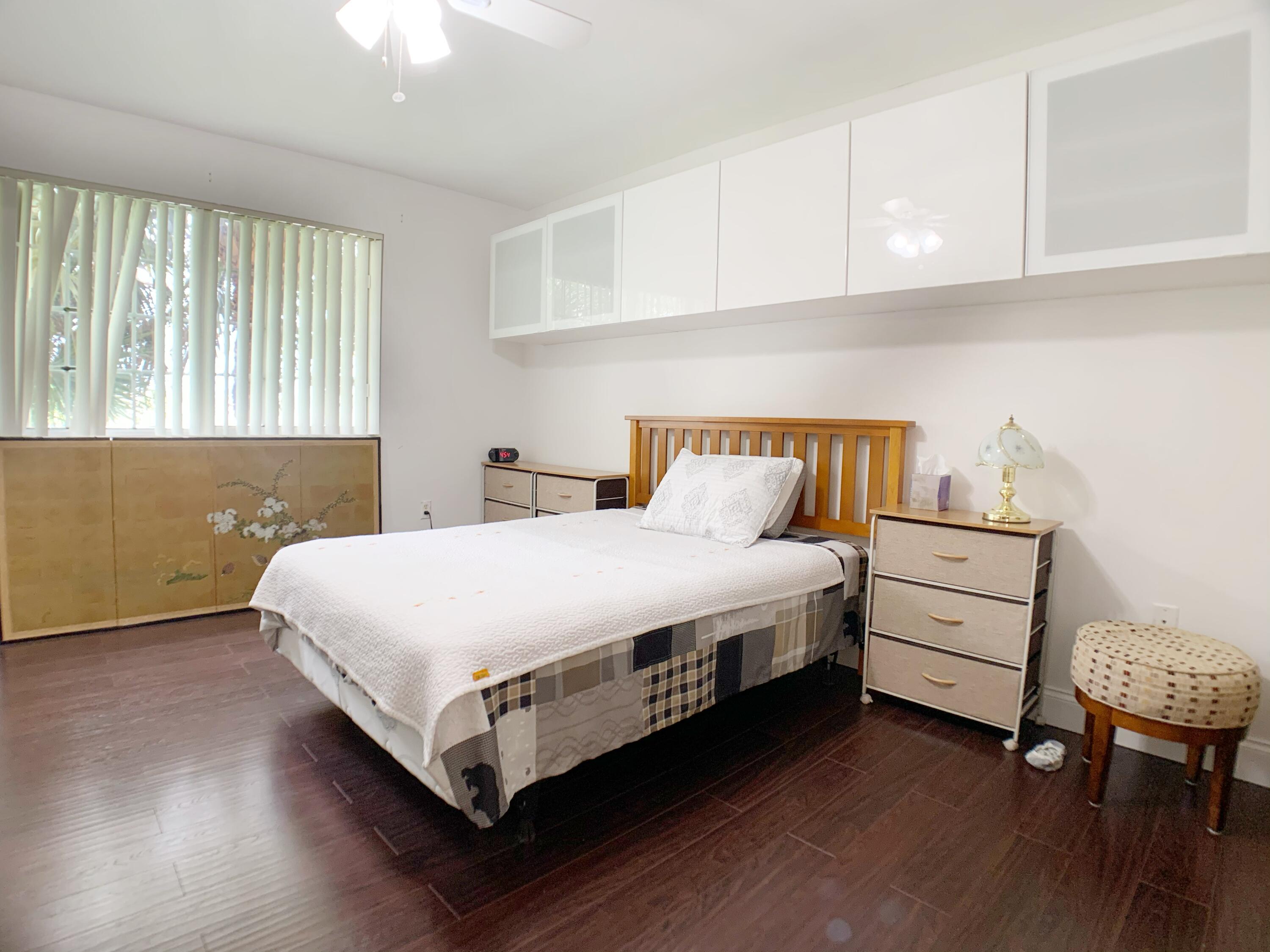 5015 Wiles Road, Unit 206 Coconut Creek, FL 33073 - Photo 22 of 32 a bedroom with a bed and a window