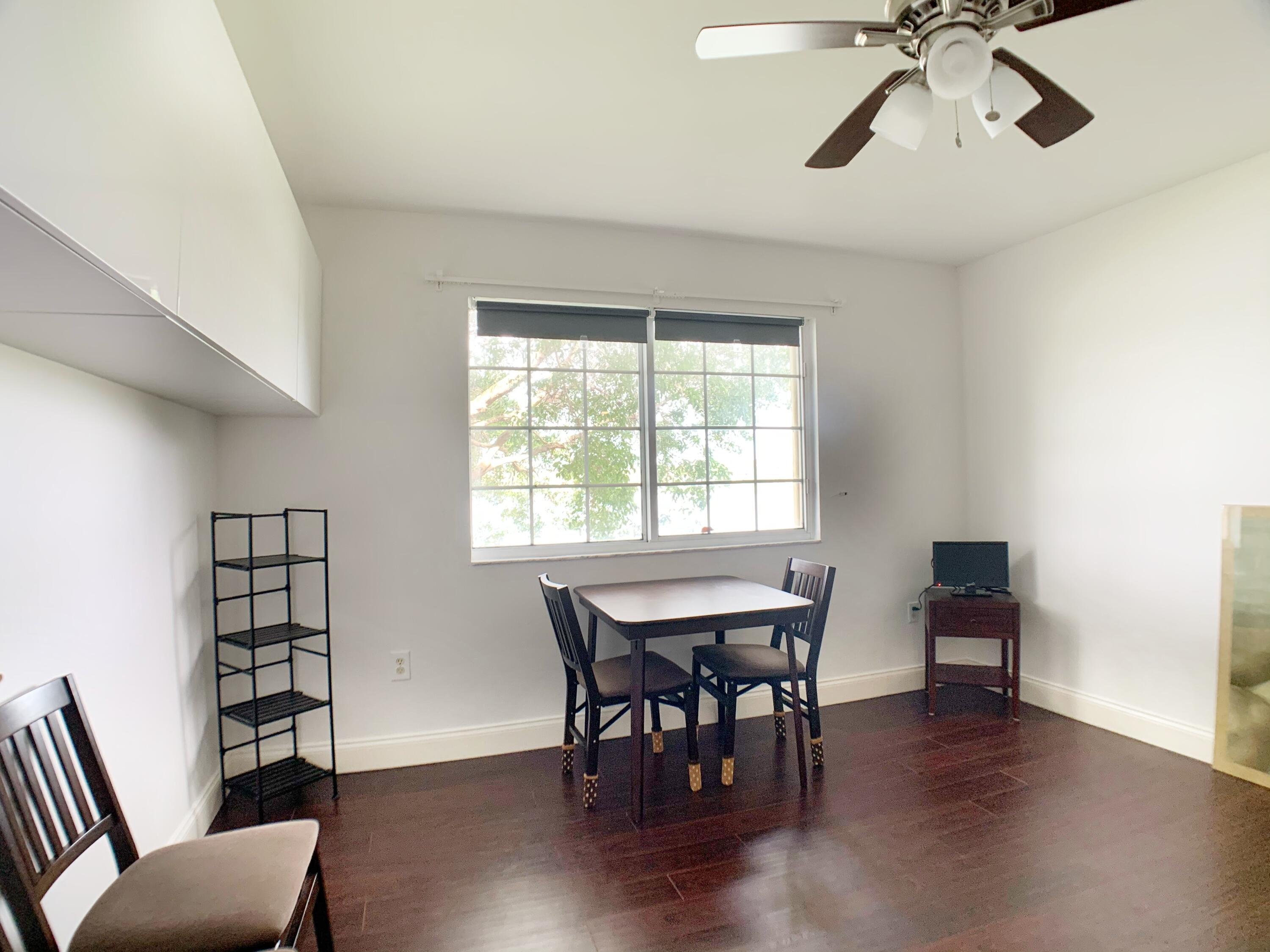 5015 Wiles Road, Unit 206 Coconut Creek, FL 33073 - Photo 24 of 32 a view of a livingroom with furniture and window