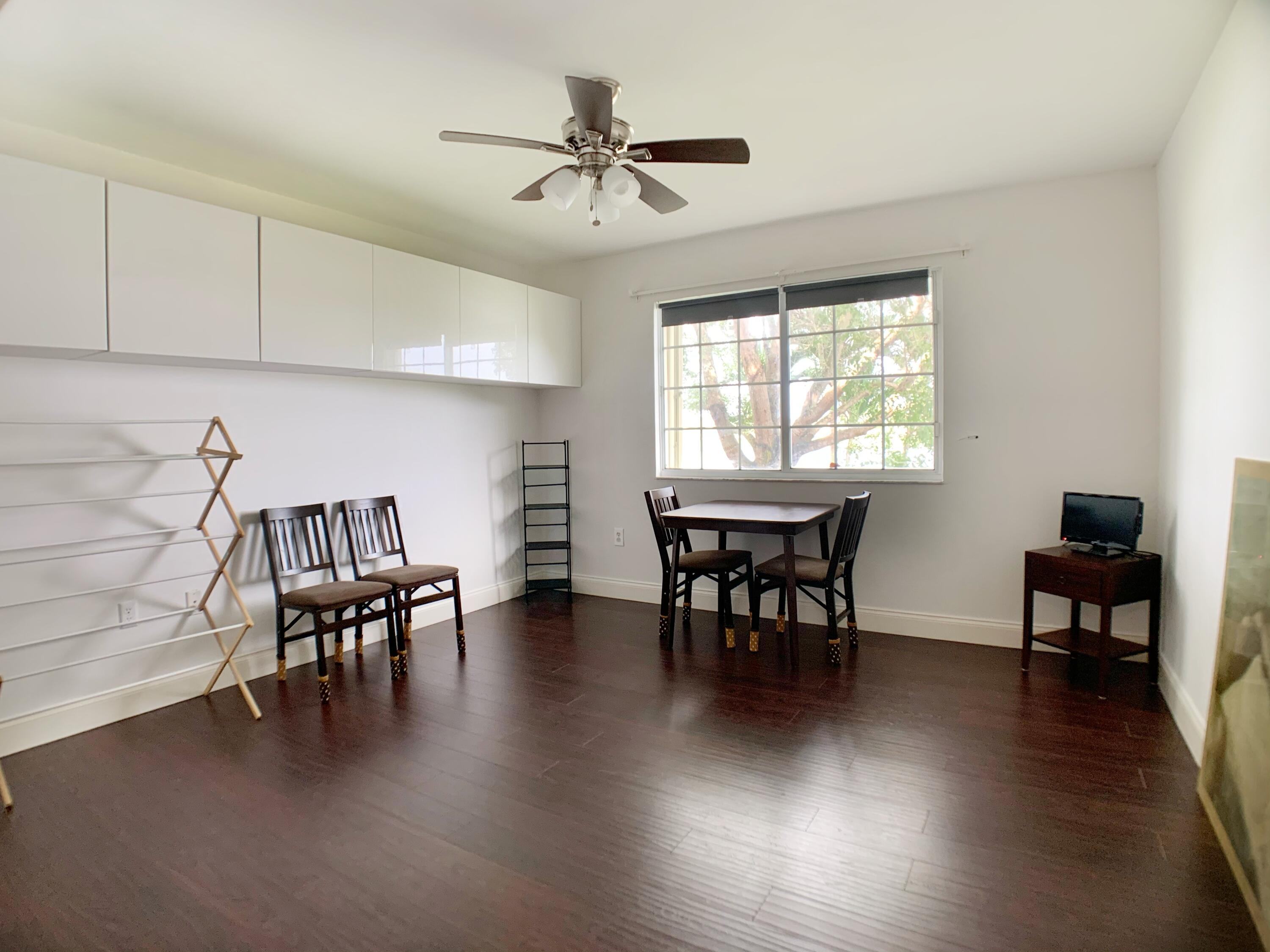 5015 Wiles Road, Unit 206 Coconut Creek, FL 33073 - Photo 25 of 32 a view of a dining room with furniture window and wooden floor