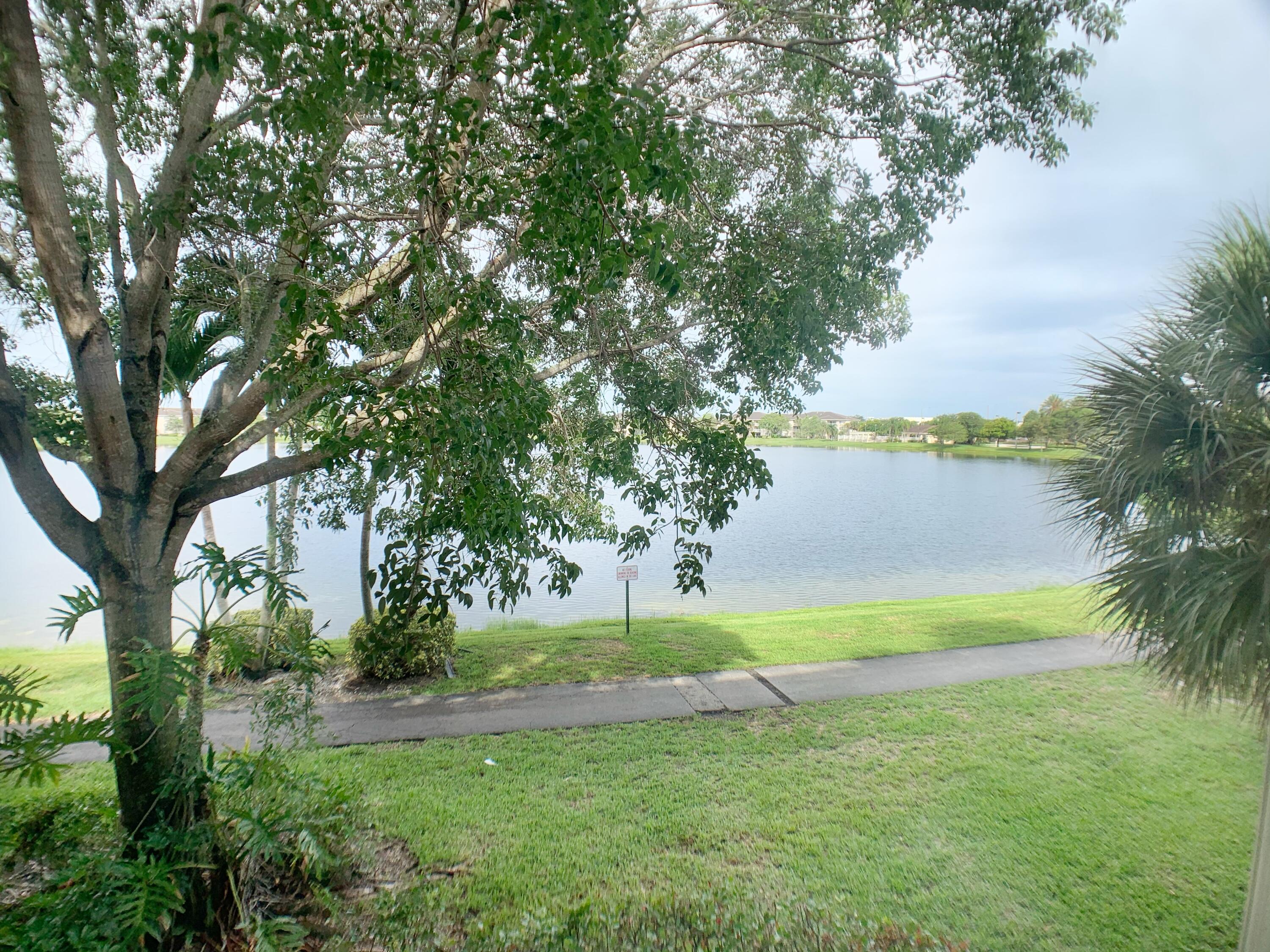5015 Wiles Road, Unit 206 Coconut Creek, FL 33073 - Photo 3 of 32 a view of a yard with a tree