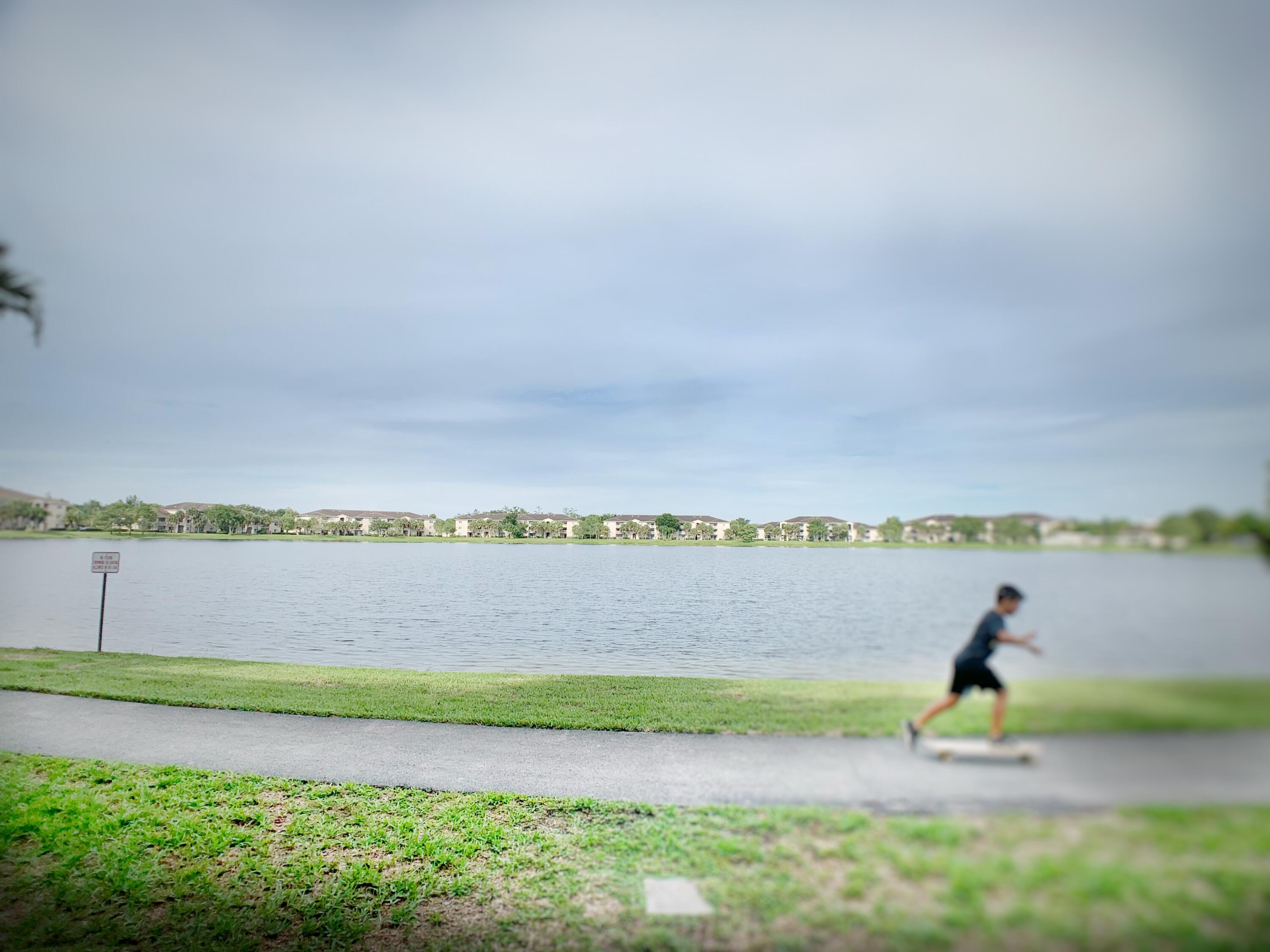 5015 Wiles Road, Unit 206 Coconut Creek, FL 33073 - Photo 31 of 32 a view of yard with two chairs and a yard