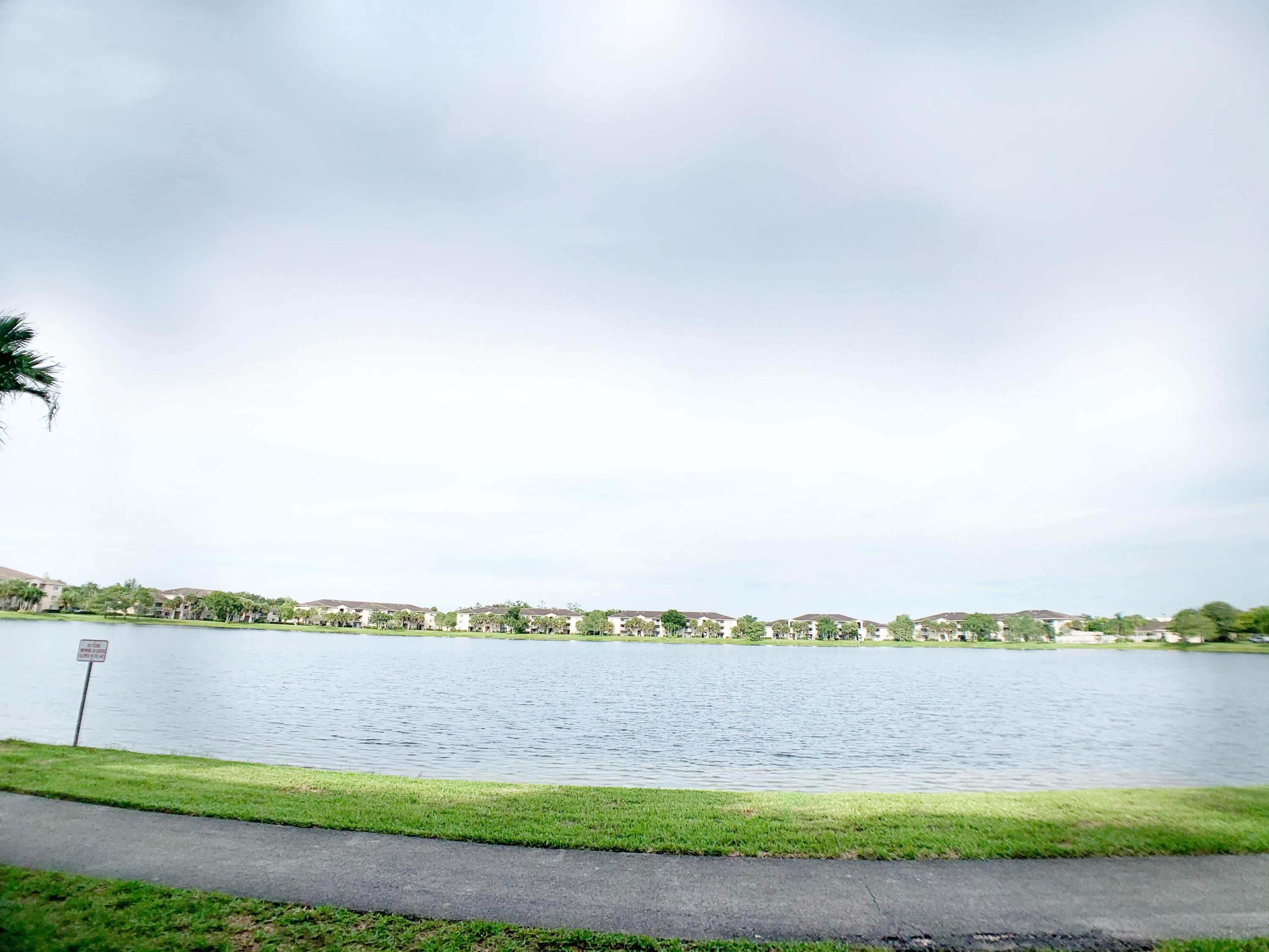 5015 Wiles Road, Unit 206 Coconut Creek, FL 33073 - Photo 32 of 32 a view of a lake with a beach