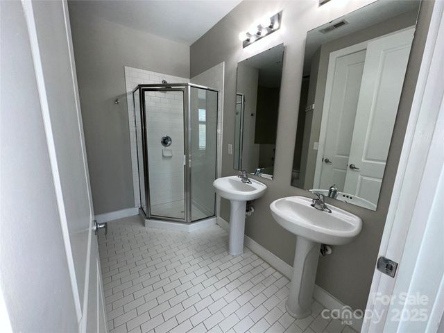 a bathroom with a sink mirror toilet and shower
