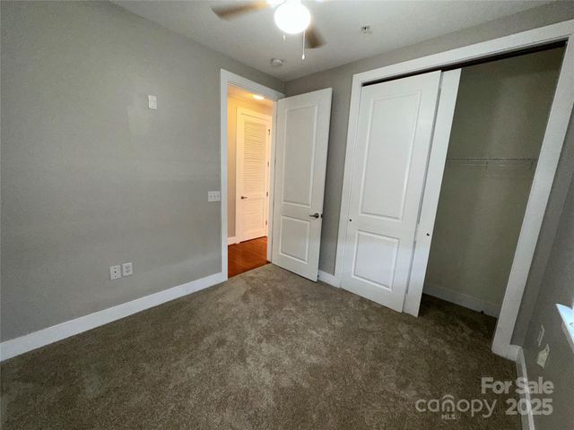 an empty room with closet and a window