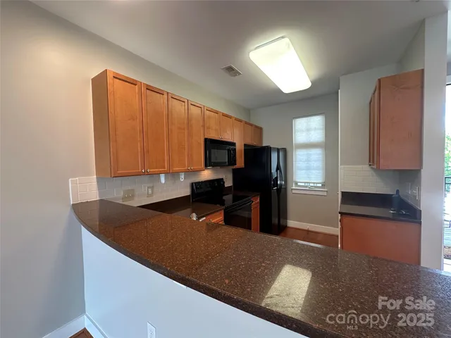 a kitchen with a sink a stove and a refrigerator