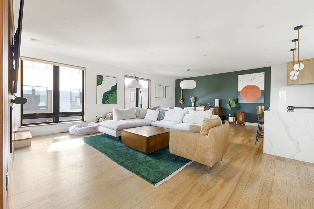 31 Hall Street, Unit 2 Waltham, MA 02453 - Photo 1 of 23 a living room with fireplace furniture and a large window