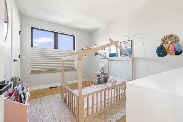a bedroom with furniture and baby crib
