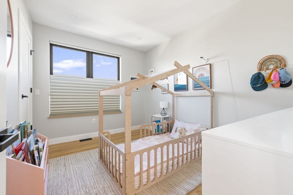 31 Hall Street, Unit 2 Waltham, MA 02453 - Photo 13 of 23 a bedroom with furniture and baby crib