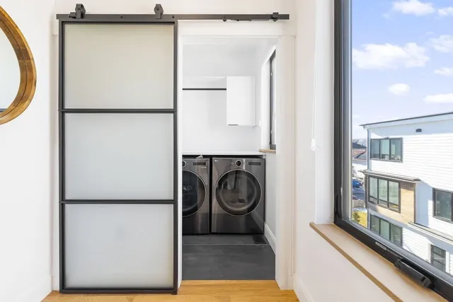 a view of a hallway with washer and dryer