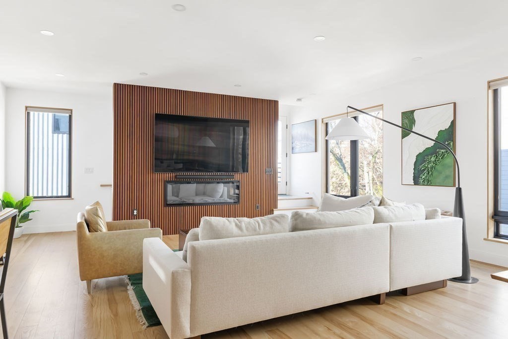 31 Hall Street, Unit 2 Waltham, MA 02453 - Photo 2 of 23 a living room with furniture and a flat screen tv